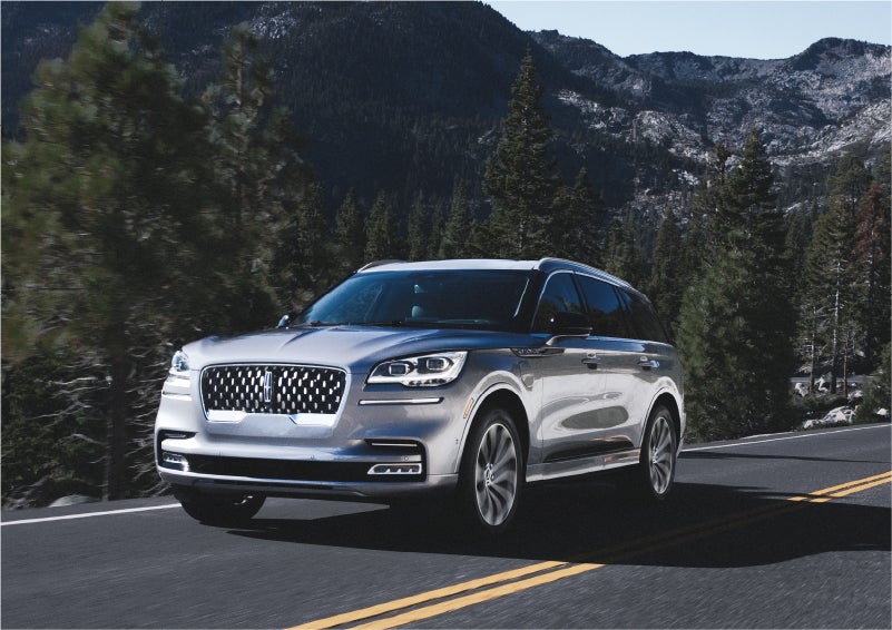 A 2023 Lincoln Aviator® Grand Touring SUV being driven on a winding road to demonstrate the capabilities of all-wheel drive | Bayway Lincoln in Houston TX