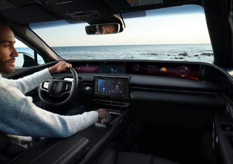A driver of a parked 2024 Lincoln Nautilus® SUV takes a relaxing moment at a seaside overlook while inside his Nautilus. | Bayway Lincoln in Houston TX