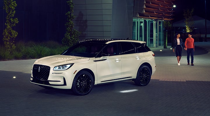 Two people approach a 2024 Lincoln Corsair® SUV featuring the available Jet Appearance Package. | Bayway Lincoln in Houston TX