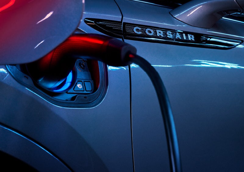 A 2025 Lincoln Corsair® Grand Touring model is shown being charged via the driver's side charging port.