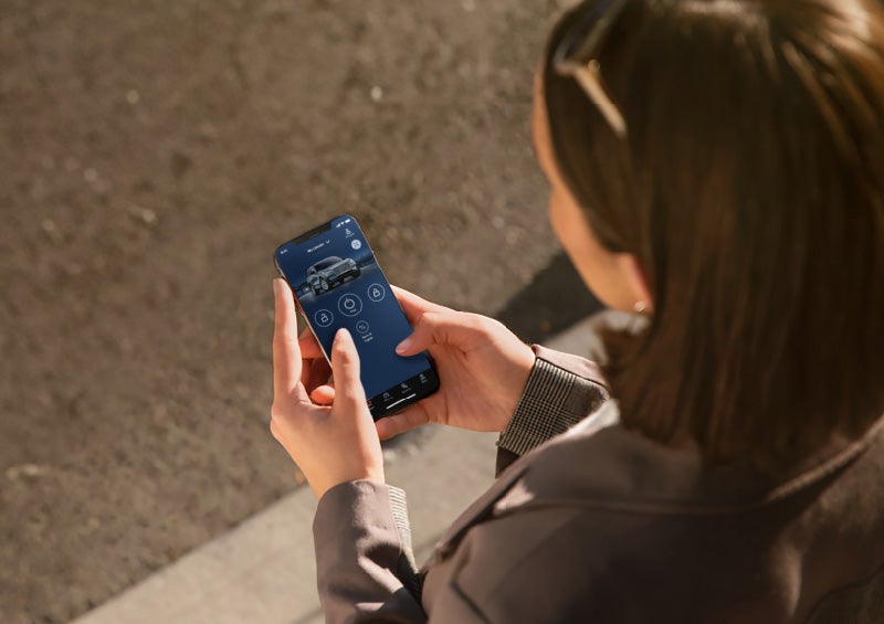 A person is shown interacting with a smartphone to connect to a Lincoln vehicle via the Lincoln Way® App.
