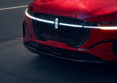 The available front LED light bar and center Lincoln Star logo glow at dusk. | Bayway Lincoln in Houston TX