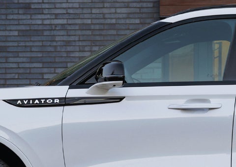 The driver’s side door and fender badging of a white 2026 Lincoln Aviator® SUV are showcased. | Bayway Lincoln in Houston TX