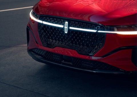 The available front LED light bar and center Lincoln Star logo glow at dusk. | Bayway Lincoln in Houston TX