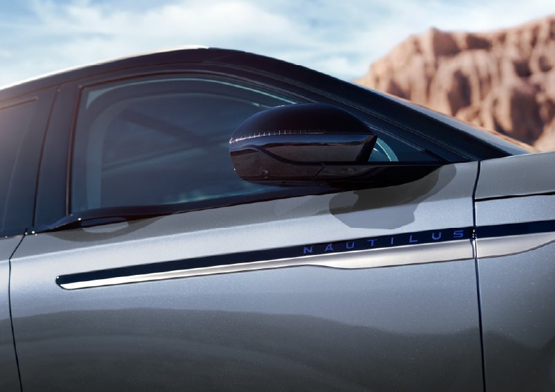 Blue lettering on the side of the vehicle that reads Nautilus indicates the available Hybrid Powertrain. | Bayway Lincoln in Houston TX