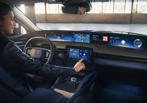 The driver of a 2026 Lincoln Nautilus® SUV interacts with the center touchscreen. | Bayway Lincoln in Houston TX
