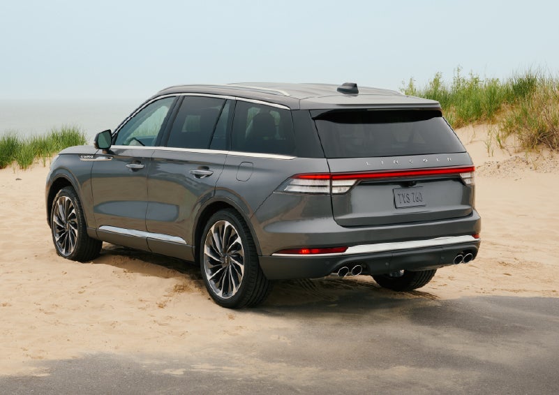 A 2027 Lincoln Aviator® SUV is parked next to sand dunes. | Bayway Lincoln in Houston TX