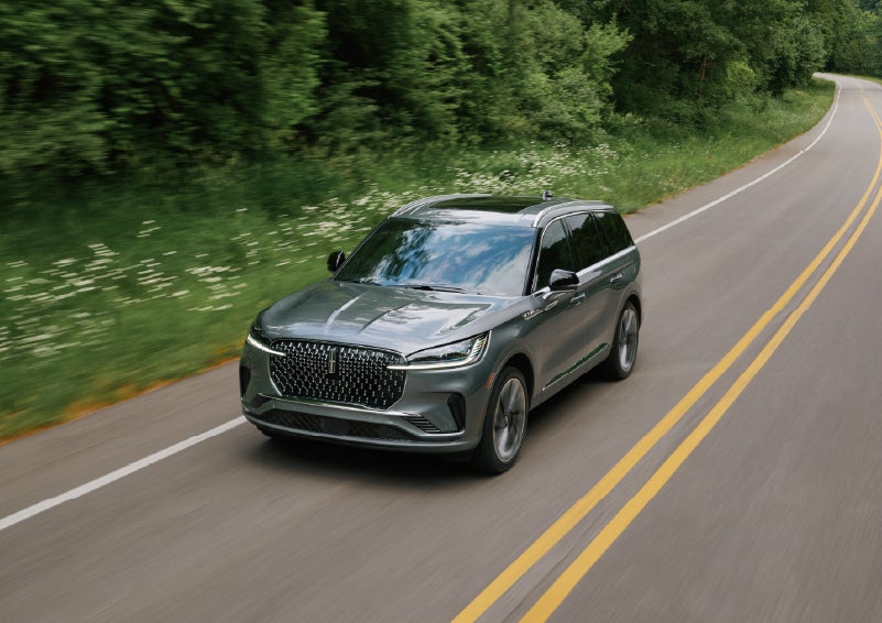 A 2027 Lincoln Aviator® SUV is being driven down a road. | Bayway Lincoln in Houston TX