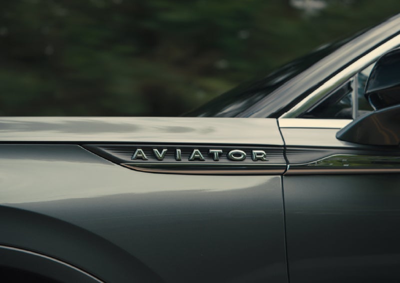 The driver’s side door and fender badging of a gray 2027 Lincoln Aviator® SUV are showcased. | Bayway Lincoln in Houston TX
