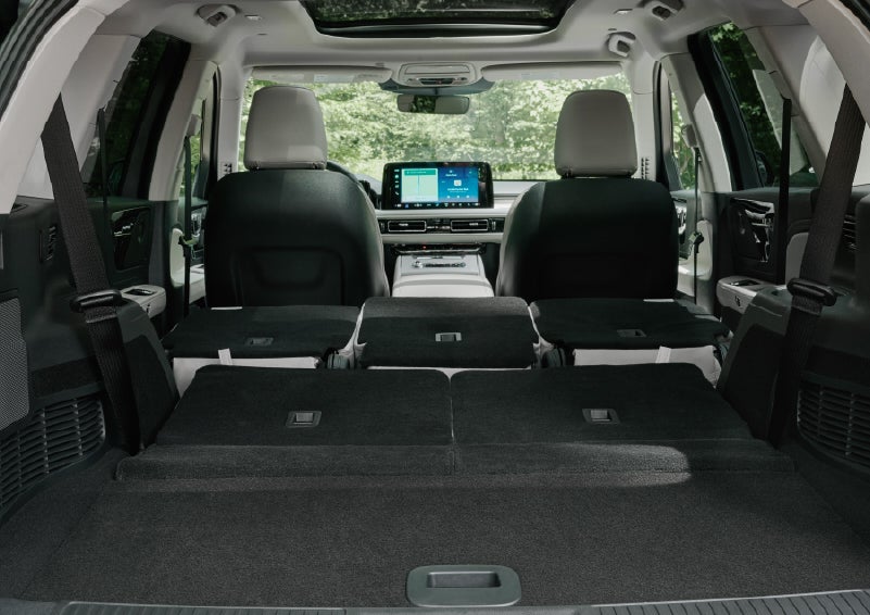 A rear to front view of the interior of a 2027 Lincoln Aviator® Black Label™ SUV shows the third and second rows folded flat | Bayway Lincoln in Houston TX