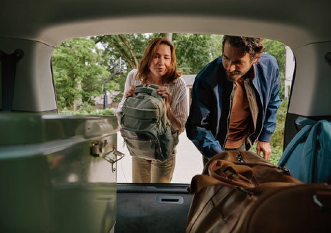 A couple loads luggage into the rear of a 2027 Lincoln Aviator® Black Label™ SUV..e 202 | Bayway Lincoln in Houston TX