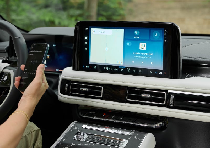 A person pairs thier phone with the center touchscreen of a 2027 Lincoln Aviator® Black Label™ SUV | Bayway Lincoln in Houston TX