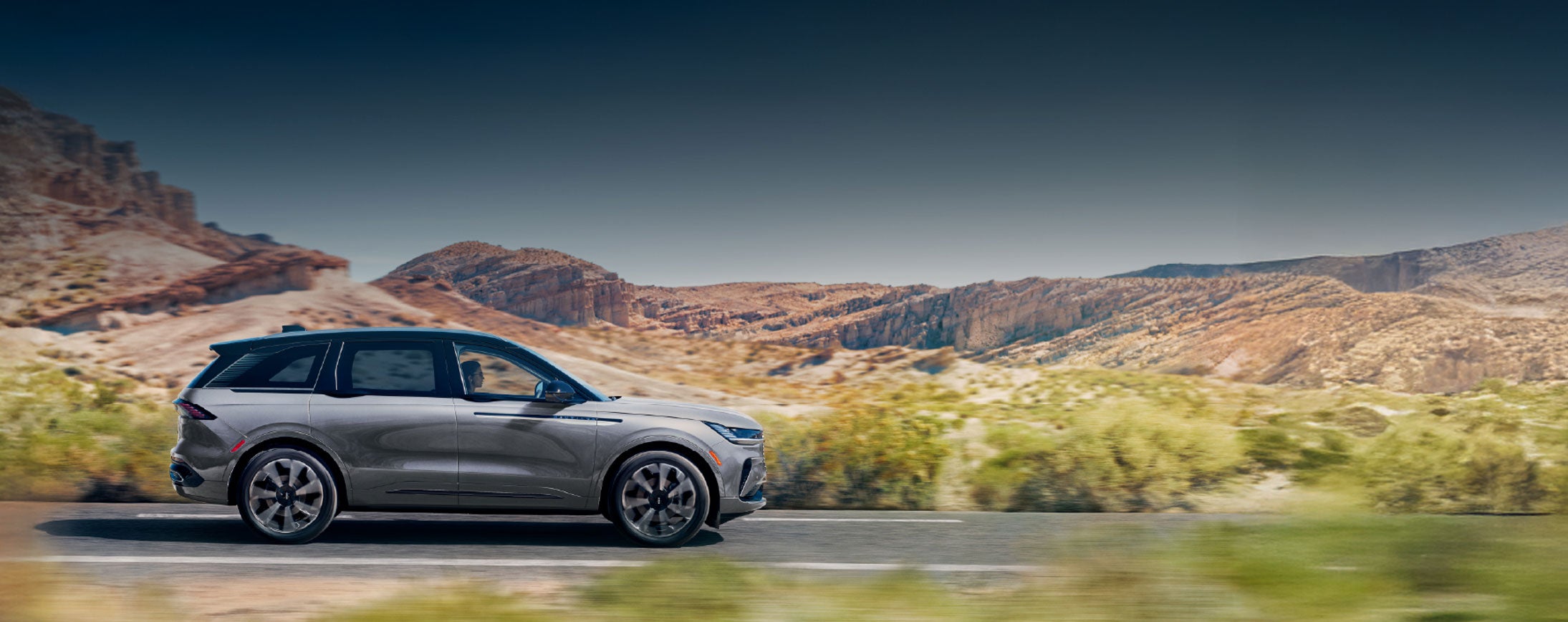 A 2026 Lincoln Nautilus® SUV is being driven on a desert highway.